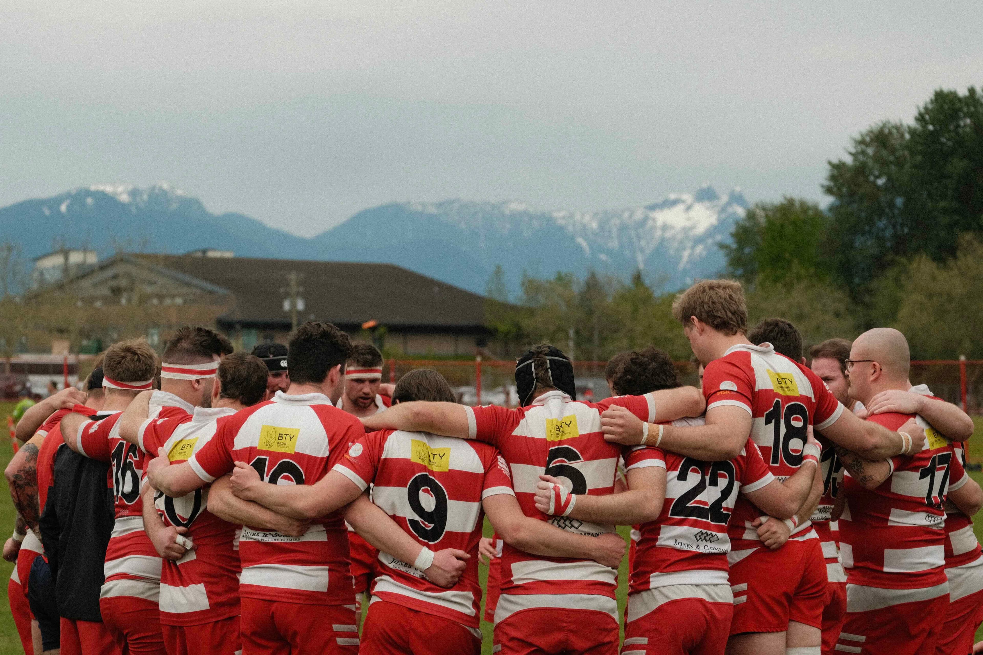 Vancouver Rowing Club Rugby team huddle at Brockton Oval