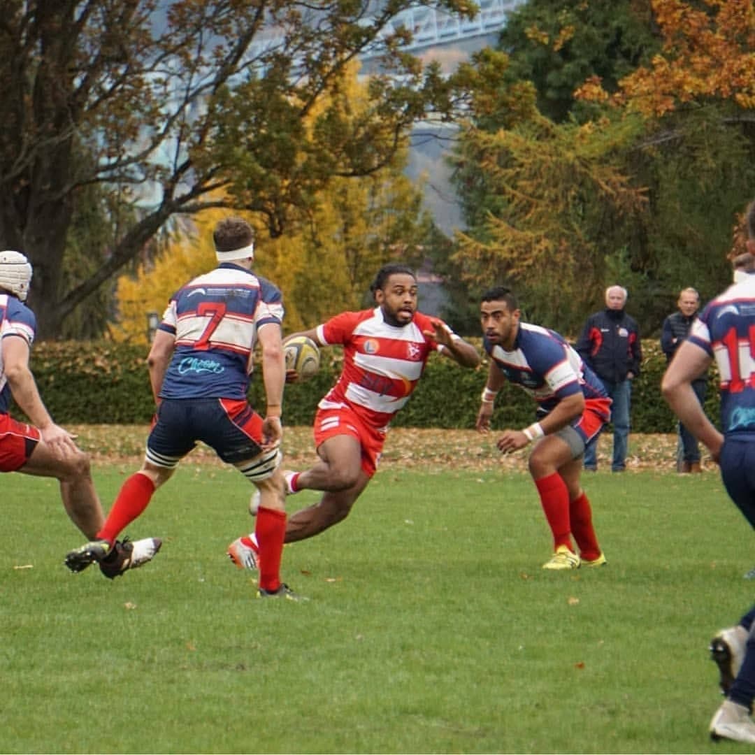VRC Rugby player breaking through the defensive line at Brockton Oval in Stanley Park